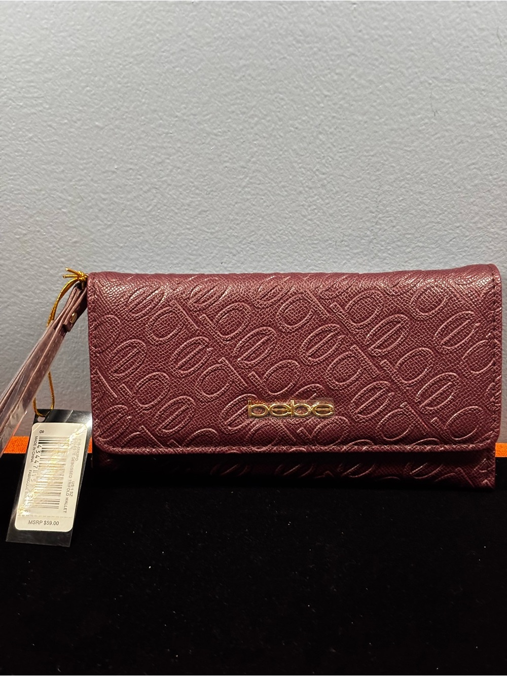 bebe Embossed Logo Wristlet Clutch in Plum